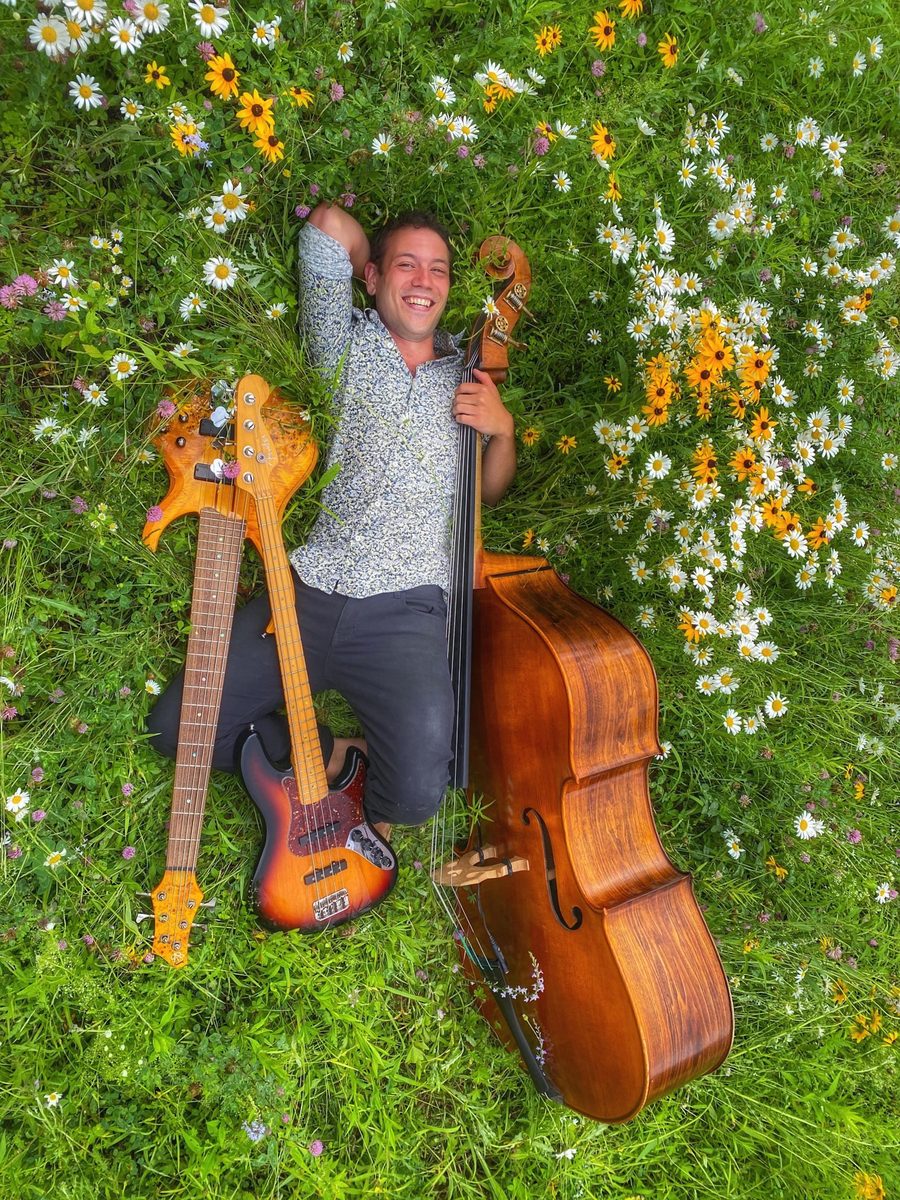 Mowgli Giannitti among wildflowers with an upright bass