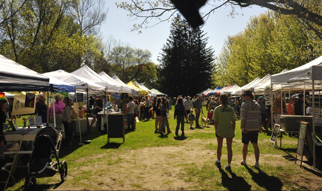 Shoppers and tents on the Shelburne Parade Grounds on a market Saturday.