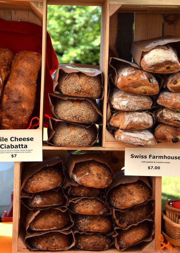 Artisan bread loaves stacked in wooden crates