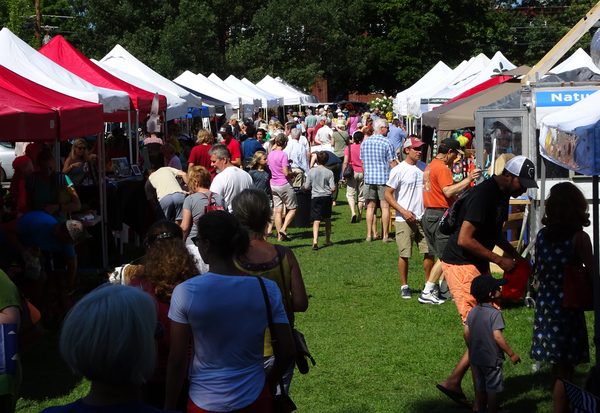 Crowds browsing vendor tents on the Parade Grounds